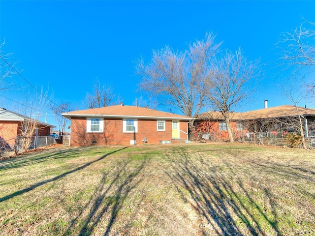 rear view of property with a yard