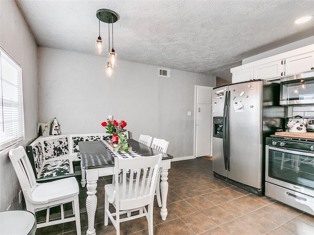 dining room with a textured ceiling