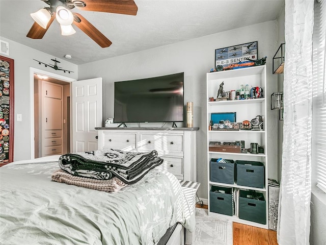 bedroom featuring light hardwood / wood-style flooring and ceiling fan