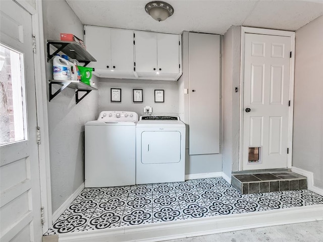 laundry area featuring cabinets, separate washer and dryer, and light tile patterned floors