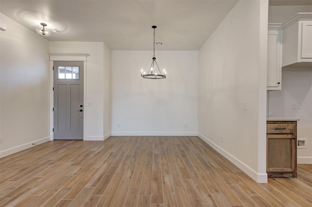 entryway featuring a notable chandelier and light wood-type flooring