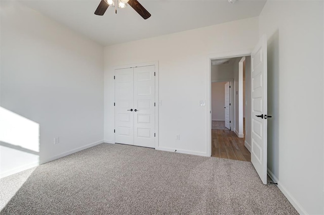 unfurnished bedroom with carpet, a closet, and ceiling fan