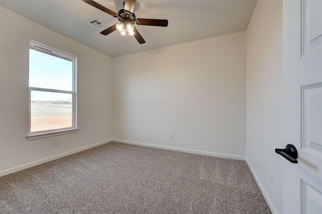 carpeted spare room with ceiling fan