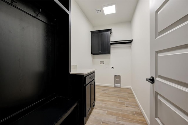 laundry room with cabinets, hookup for an electric dryer, and hookup for a washing machine