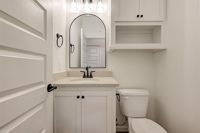 bathroom featuring toilet and vanity