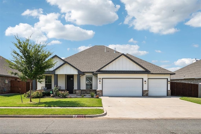 craftsman house with a garage and a front lawn