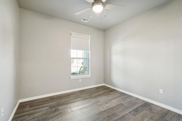 unfurnished room featuring dark wood-type flooring and ceiling fan