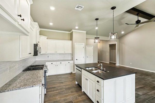 kitchen featuring sink, stainless steel appliances, an island with sink, and white cabinets