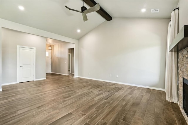 unfurnished living room with hardwood / wood-style floors, a stone fireplace, vaulted ceiling with beams, and ceiling fan