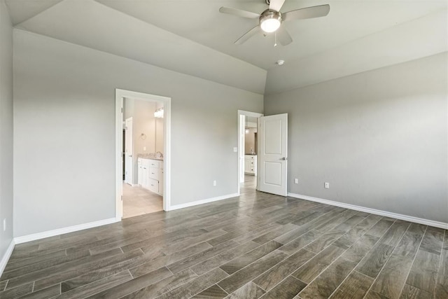 unfurnished bedroom with dark hardwood / wood-style flooring, connected bathroom, lofted ceiling, and ceiling fan