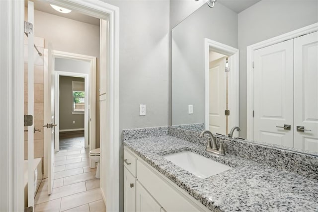 bathroom with vanity, tile patterned floors, and toilet