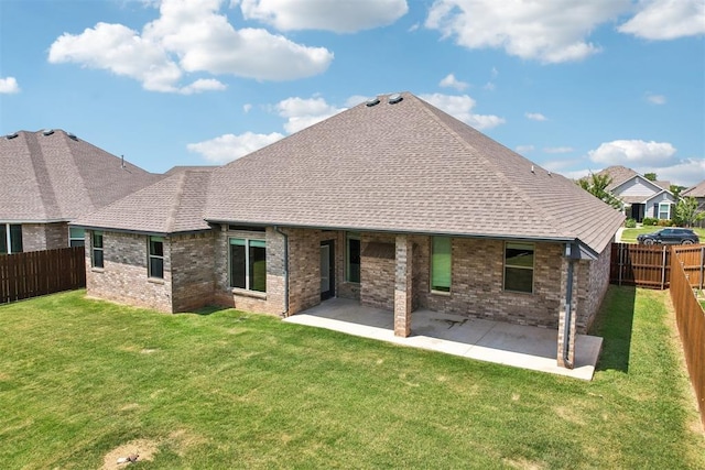 rear view of house with a lawn and a patio