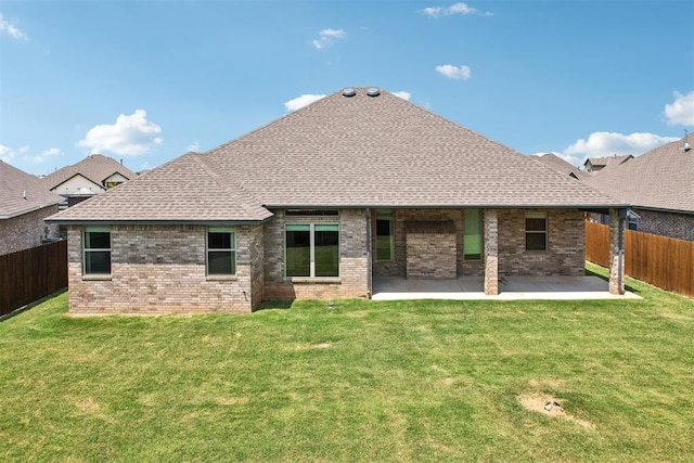 rear view of house featuring a lawn and a patio area