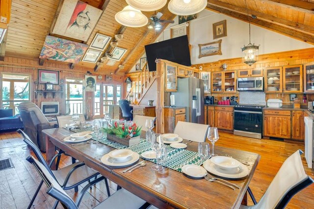 dining space with wood ceiling, plenty of natural light, light hardwood / wood-style floors, and lofted ceiling with beams