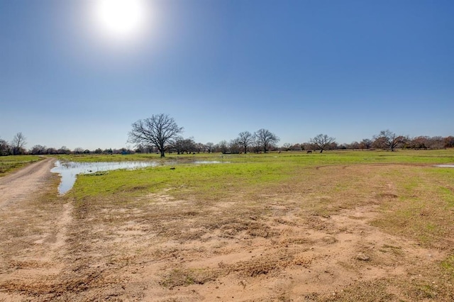 view of yard featuring a water view and a rural view