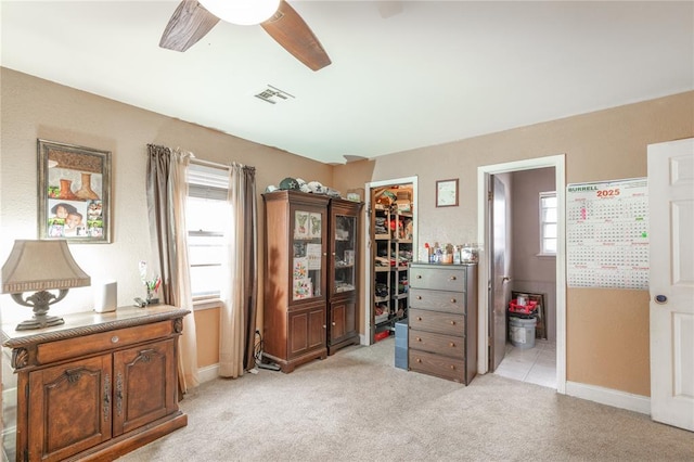 misc room with light carpet, ceiling fan, and a healthy amount of sunlight