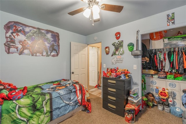 bedroom with ceiling fan, carpet, and a closet