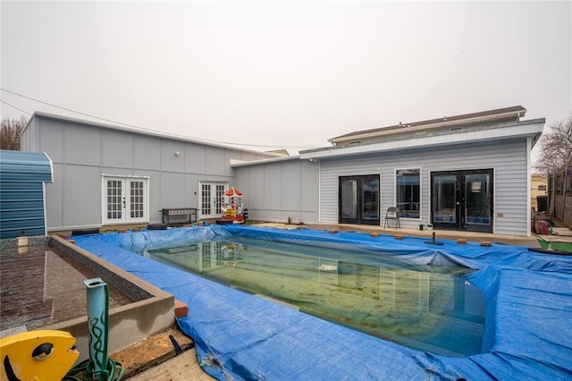 view of pool with french doors