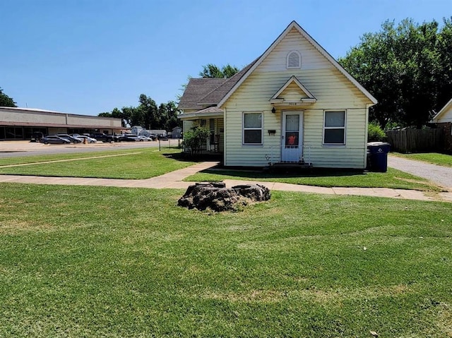 bungalow-style home featuring a front lawn