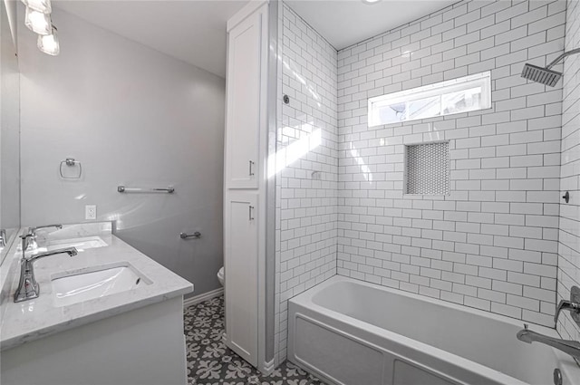 full bathroom with vanity, tiled shower / bath combo, and toilet