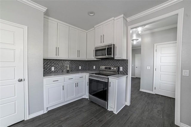 kitchen with white cabinetry, tasteful backsplash, ornamental molding, and appliances with stainless steel finishes