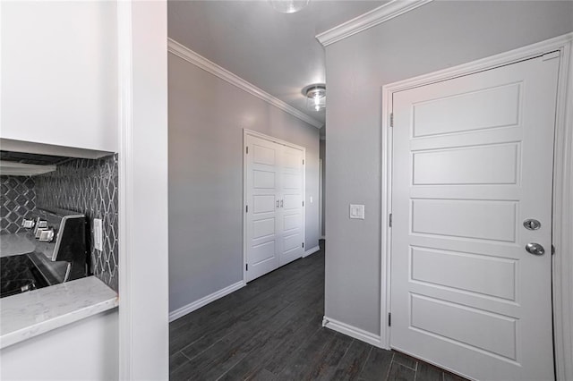 corridor with ornamental molding and dark hardwood / wood-style floors