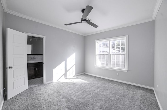 spare room with crown molding, light colored carpet, and ceiling fan