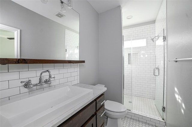 bathroom with walk in shower, toilet, tasteful backsplash, vanity, and tile patterned flooring