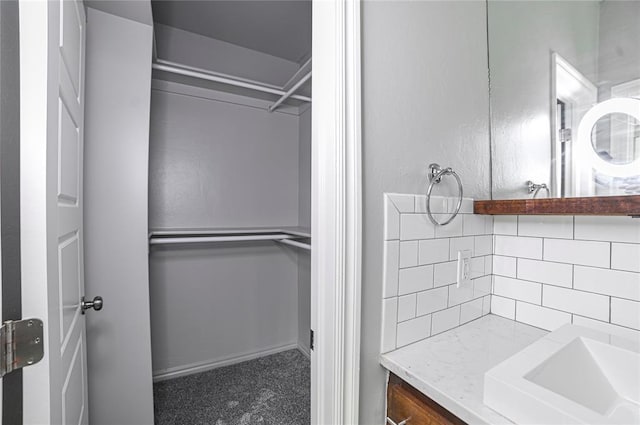 bathroom featuring vanity and decorative backsplash