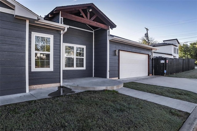 view of front of property featuring a garage and a front lawn