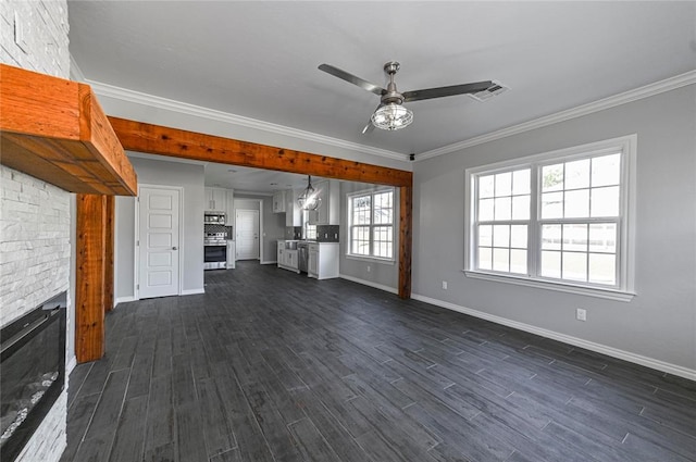 unfurnished living room featuring dark hardwood / wood-style flooring, crown molding, and ceiling fan