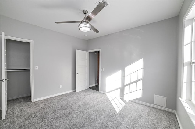 unfurnished bedroom with a closet, ceiling fan, and carpet