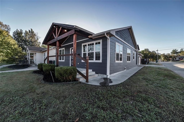 view of side of home featuring a lawn