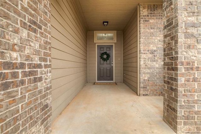 property entrance featuring brick siding