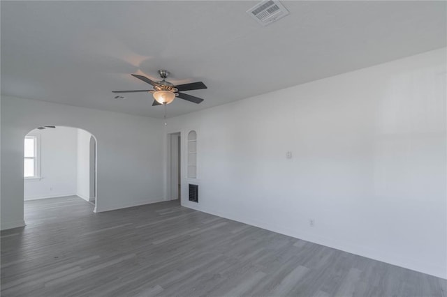 unfurnished room with ceiling fan and dark hardwood / wood-style flooring