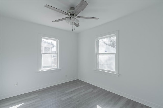 empty room with ceiling fan and light wood-type flooring