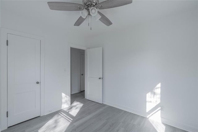 unfurnished bedroom with ceiling fan and light hardwood / wood-style flooring