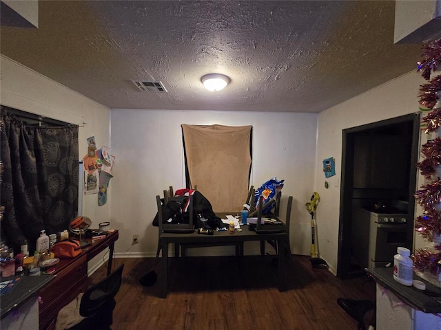 home office with hardwood / wood-style flooring and a textured ceiling