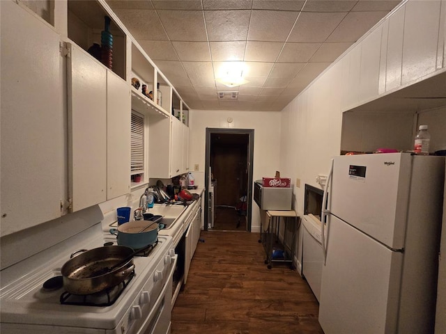 kitchen with white cabinetry, sink, dark wood-type flooring, and white fridge