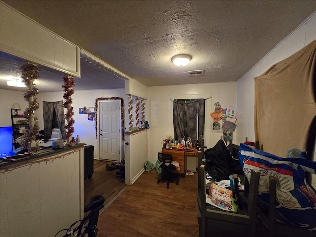 interior space featuring a textured ceiling and dark hardwood / wood-style flooring