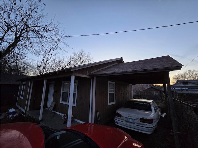 property exterior at dusk with a carport