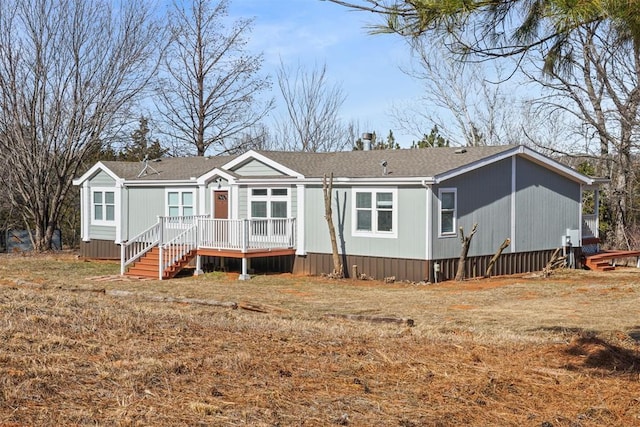 rear view of property featuring a deck