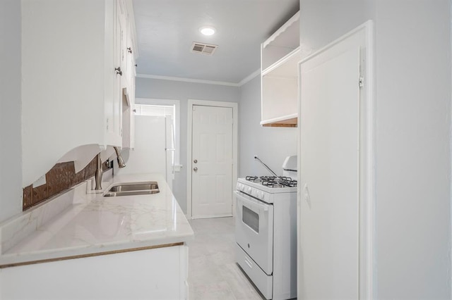 kitchen featuring sink, white cabinets, white range with gas stovetop, crown molding, and light stone countertops