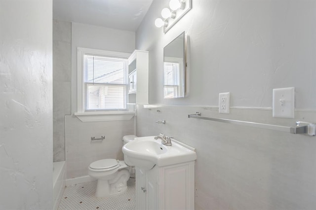 bathroom featuring vanity, tile patterned flooring, and toilet