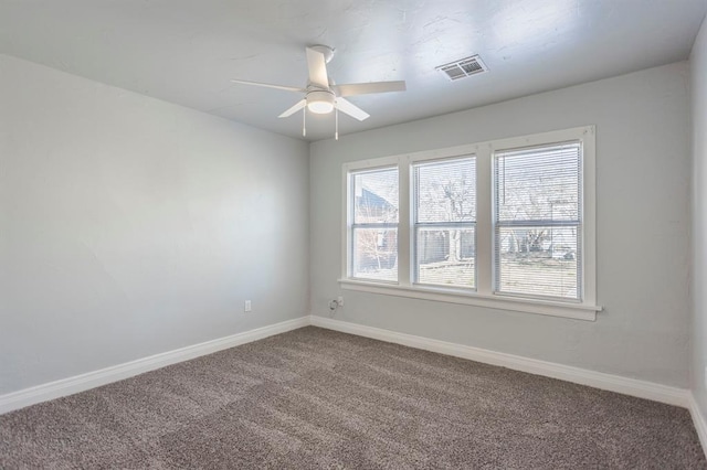 carpeted spare room with ceiling fan