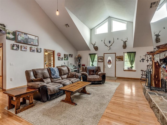 living room featuring high vaulted ceiling and hardwood / wood-style floors