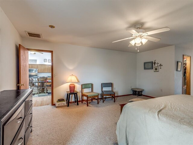 bedroom with light carpet and ceiling fan