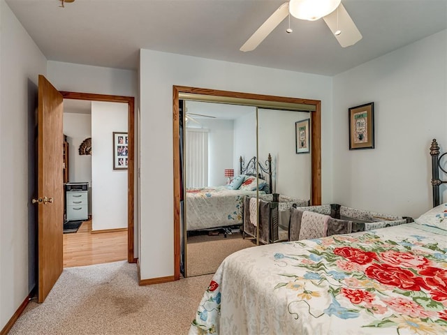 carpeted bedroom with ceiling fan and a closet