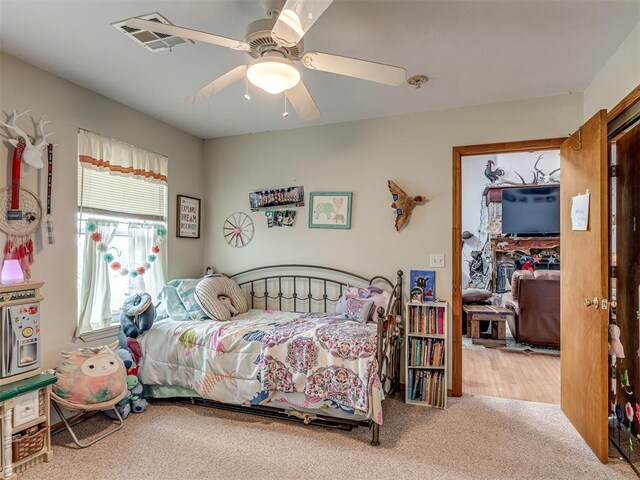 carpeted bedroom featuring ceiling fan