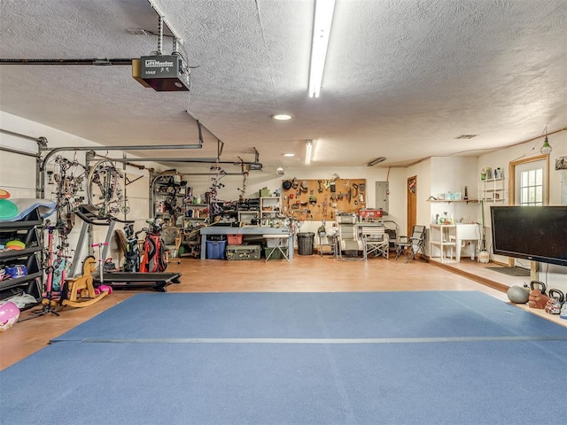 garage featuring a garage door opener and a workshop area